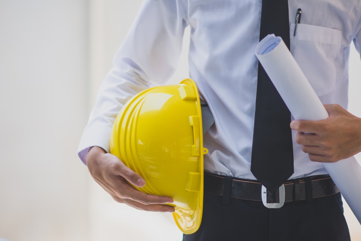 Man engineer holding helmet hard hat work construction building