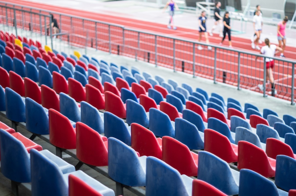Red seats in the stadium. Empty seat of football stadium.