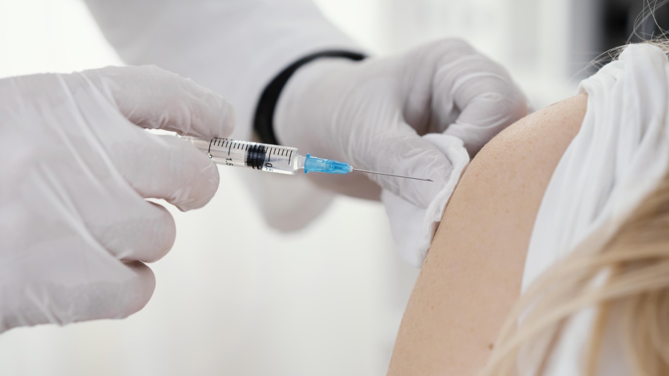 Doctor vaccinating patient clinic